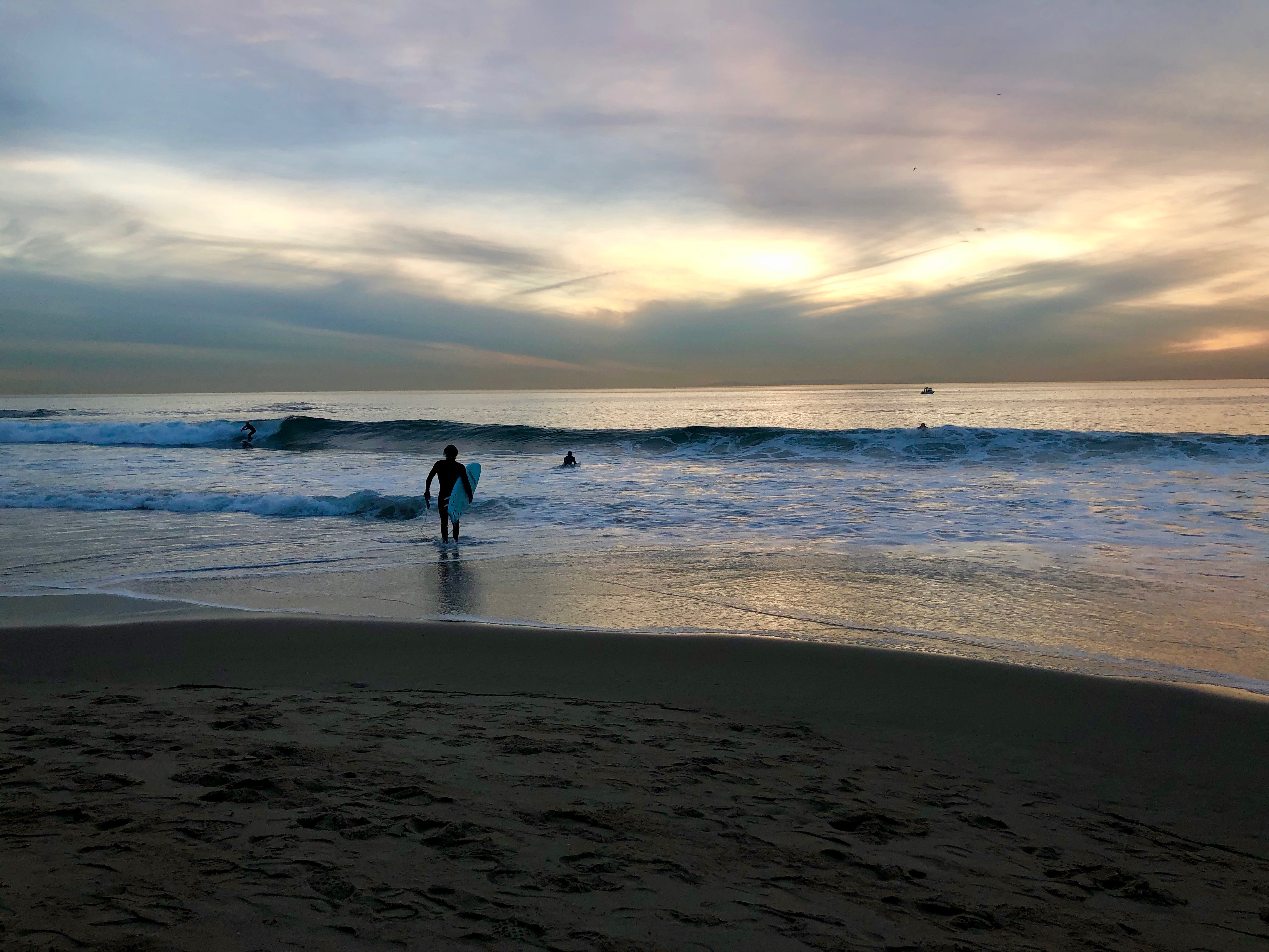 Surfer entering water at 3.5 Cove