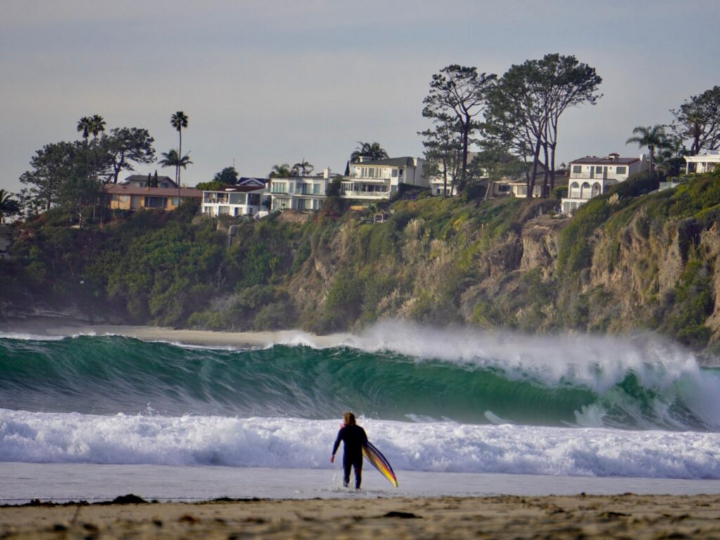 Surfer entering the ocean at Salt Creek