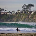 Surfer entering the ocean at Salt Creek